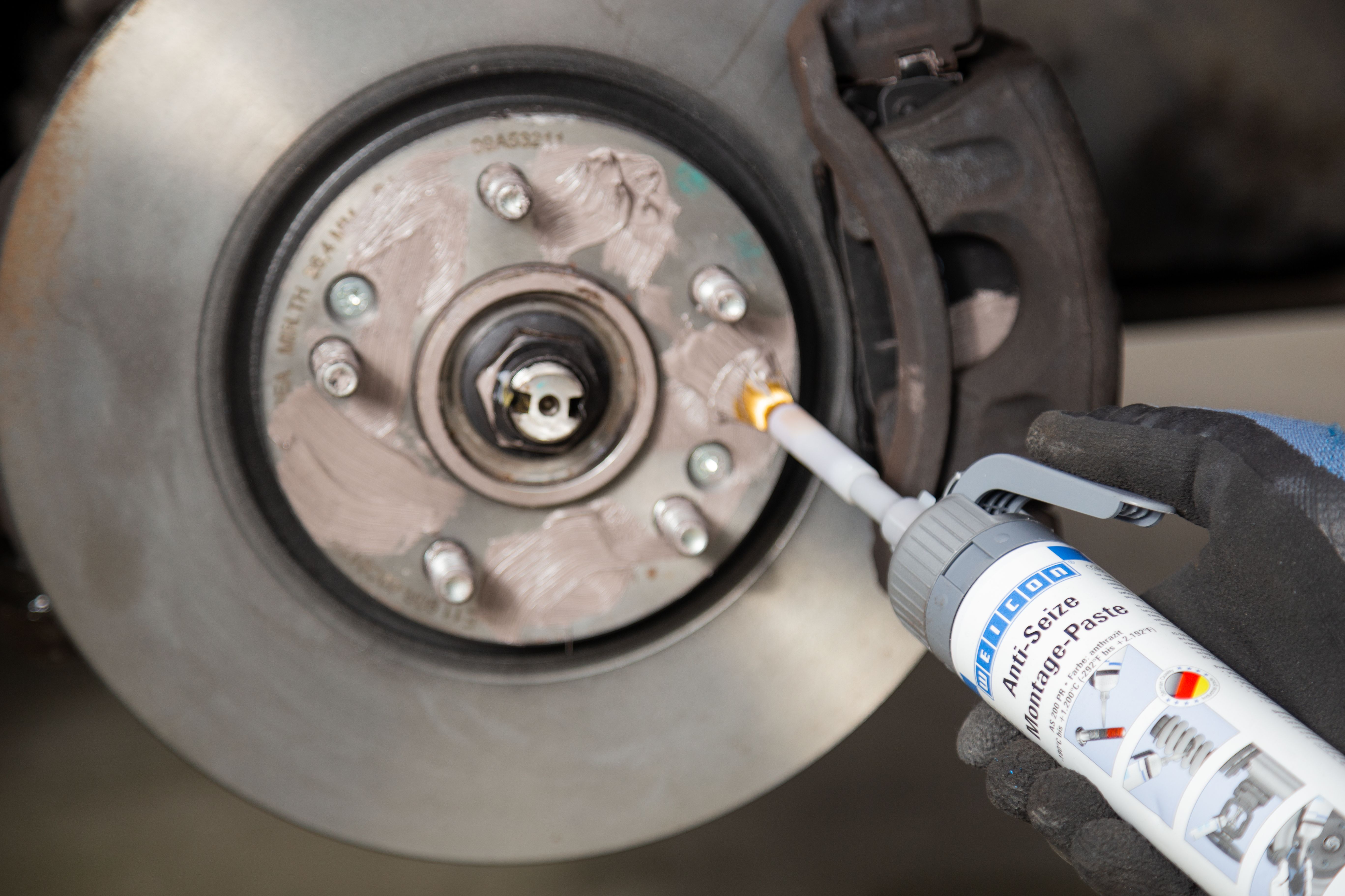 Anti-seize assembly paste is applied to a brake drum